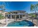 Beautiful backyard with a large pool, covered patio, and desert landscaping at 11446 E Sweetwater Ave, Scottsdale, AZ 85259