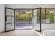 View from balcony through iron doors showcases desert landscaping and luxury community at 11446 E Sweetwater Ave, Scottsdale, AZ 85259