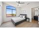 Serene bedroom features a large window, providing plenty of natural light and views of the landscape at 11446 E Sweetwater Ave, Scottsdale, AZ 85259