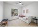 Bright bedroom with a daybed, a ceiling fan and view from a window at 11446 E Sweetwater Ave, Scottsdale, AZ 85259