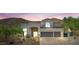 Charming two story home featuring a tile roof, stucco walls, and large two car garage at 11446 E Sweetwater Ave, Scottsdale, AZ 85259