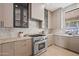 Modern kitchen featuring marble countertops, stainless steel appliances, and stylish cabinetry at 11446 E Sweetwater Ave, Scottsdale, AZ 85259