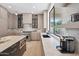 Gourmet kitchen with marble countertops, stainless steel appliances, and light and dark wood cabinetry at 11446 E Sweetwater Ave, Scottsdale, AZ 85259