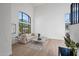 Bright, light filled living room with soaring arched windows and neutral color palette at 11446 E Sweetwater Ave, Scottsdale, AZ 85259
