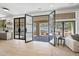 Open living area featuring wood floors, modern light fixture, and seamless indoor-outdoor living at 11446 E Sweetwater Ave, Scottsdale, AZ 85259
