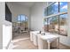 Open-concept living room with dining area featuring large windows and neutral color scheme at 11446 E Sweetwater Ave, Scottsdale, AZ 85259