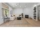 Spacious living room showcasing a fireplace, cozy seating, and a seamless indoor-outdoor transition at 11446 E Sweetwater Ave, Scottsdale, AZ 85259