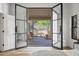 Bedroom with double doors opening to an outdoor living space with spiral staircase at 11446 E Sweetwater Ave, Scottsdale, AZ 85259