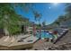 Backyard oasis featuring a swimming pool, pillars, and a serene desert landscape at 11446 E Sweetwater Ave, Scottsdale, AZ 85259