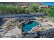 Backyard featuring a freeform pool with a waterfall and a patio at 11446 E Sweetwater Ave, Scottsdale, AZ 85259