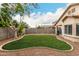 Manicured backyard features lush green grass, mature tree, and privacy wall at 12355 W Lincoln St, Avondale, AZ 85323