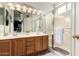 Bright bathroom with dual sink vanity, wood cabinets, and glass enclosed shower at 12355 W Lincoln St, Avondale, AZ 85323