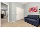 Bedroom features a futon, closet, and doorway to the living room at 12355 W Lincoln St, Avondale, AZ 85323