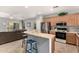 Kitchen featuring stainless steel appliances and a breakfast bar seamlessly integrated with the living area at 12355 W Lincoln St, Avondale, AZ 85323