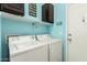 Laundry room features front loading washer and dryer with overhead shelving at 12355 W Lincoln St, Avondale, AZ 85323