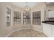 Charming breakfast nook featuring bright natural lighting and a chandelier at 13015 W Blue Sky Dr, Sun City West, AZ 85375
