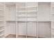 Spacious walk-in closet with built-in shelving and ample storage space for clothes and accessories at 13015 W Blue Sky Dr, Sun City West, AZ 85375