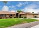 Well-maintained home featuring a lush green lawn, colorful landscaping, and a neatly manicured garden at 13015 W Blue Sky Dr, Sun City West, AZ 85375
