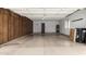 Spacious garage with built-in wooden cabinets for storage and a water heater at 13015 W Blue Sky Dr, Sun City West, AZ 85375