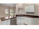 Bright kitchen features a modern stainless steel dishwasher and a window over the sink at 13015 W Blue Sky Dr, Sun City West, AZ 85375