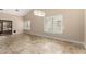 Open living space boasts tile flooring, shuttered windows and a decorative light fixture at 13015 W Blue Sky Dr, Sun City West, AZ 85375