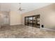 Spacious living area features tile flooring and sliding glass doors leading to outdoor space at 13015 W Blue Sky Dr, Sun City West, AZ 85375