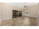Bright living area with tile flooring, ceiling fan, sliding glass doors, and windows at 13015 W Blue Sky Dr, Sun City West, AZ 85375