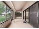 Covered patio with screening and sliding glass doors at 13015 W Blue Sky Dr, Sun City West, AZ 85375