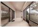 Covered patio with screens, sliding glass doors, and neutral colored walls at 13015 W Blue Sky Dr, Sun City West, AZ 85375