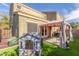 This backyard has lush artificial grass, privacy, and a charming playhouse for children to enjoy at 13540 N 87Th Dr, Peoria, AZ 85381