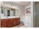 Bright bathroom features a double sink vanity, large mirror, soaking tub and updated fixtures at 13540 N 87Th Dr, Peoria, AZ 85381