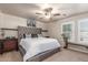 Comfortable bedroom featuring a plush bed, soft lighting, and ample natural light from the window at 13540 N 87Th Dr, Peoria, AZ 85381