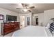 Spacious primary bedroom featuring a large bed, dresser, and view of the ensuite bathroom at 13540 N 87Th Dr, Peoria, AZ 85381