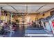 The garage is currently outfitted as a home gym with various equipment and plenty of room at 13540 N 87Th Dr, Peoria, AZ 85381