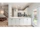 Modern kitchen featuring white cabinetry, quartz countertops, stainless appliances, and a view to the dining area at 13540 N 87Th Dr, Peoria, AZ 85381
