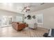 Bright living room featuring modern decor, neutral tones, herringbone floors, and french doors to the backyard at 13540 N 87Th Dr, Peoria, AZ 85381