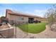 Back yard featuring artificial turf, stone pathway, desert landscaping and block wall at 14417 N 151St Dr, Surprise, AZ 85379