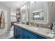 Bathroom featuring double sinks, large mirrors, cabinets and tiled floors at 14417 N 151St Dr, Surprise, AZ 85379