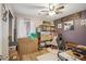 Versatile bonus room is used as an office space; the room is filled with decor and storage at 14417 N 151St Dr, Surprise, AZ 85379