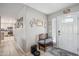 Warm entryway with a decorative bench, tiled floors, and neutral walls adorned with tasteful decor at 14417 N 151St Dr, Surprise, AZ 85379