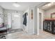 Inviting entryway showcasing tiled floors, a stylish bench, and a well-lit space with a neutral color palette at 14417 N 151St Dr, Surprise, AZ 85379