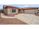 Lovely single-story home featuring a spacious driveway, desert landscaping, and attached garage at 14417 N 151St Dr, Surprise, AZ 85379