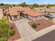 Charming single-story home showcasing a tile roof, desert landscaping, and a spacious driveway for ample parking at 14417 N 151St Dr, Surprise, AZ 85379
