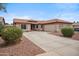 Beautiful single-story home featuring a spacious driveway, desert landscaping, and attached garage at 14417 N 151St Dr, Surprise, AZ 85379