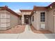 Inviting home entrance featuring a decorative door, desert landscaping, and charming accents on the exterior at 14417 N 151St Dr, Surprise, AZ 85379