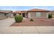 Charming single-story home with a low-maintenance desert landscape, tile roof, and spacious driveway at 14417 N 151St Dr, Surprise, AZ 85379