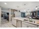 Bright kitchen with island, stone countertops, stainless steel appliances, and open floor plan to dining and living rooms at 14417 N 151St Dr, Surprise, AZ 85379