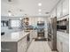 Modern kitchen featuring white cabinets, stainless steel appliances, and a large island with bar seating at 14417 N 151St Dr, Surprise, AZ 85379