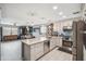 Open kitchen featuring a large island, stainless steel appliances, and ample counter space for cooking and entertaining at 14417 N 151St Dr, Surprise, AZ 85379