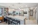 Updated kitchen boasts stainless steel appliances, granite countertops, pendant lighting, and a breakfast bar with seating at 14417 N 151St Dr, Surprise, AZ 85379